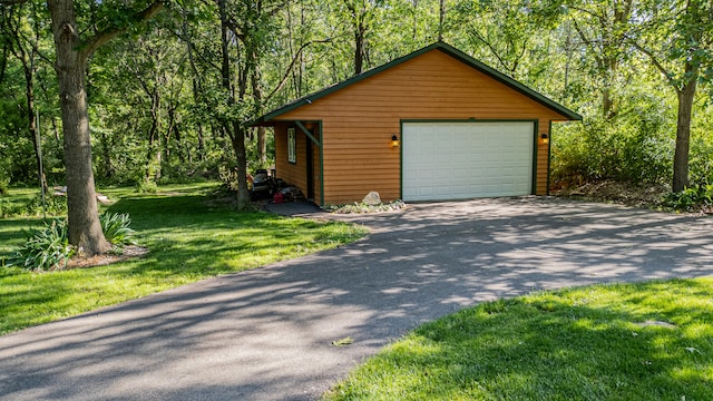 garage featuring a lawn