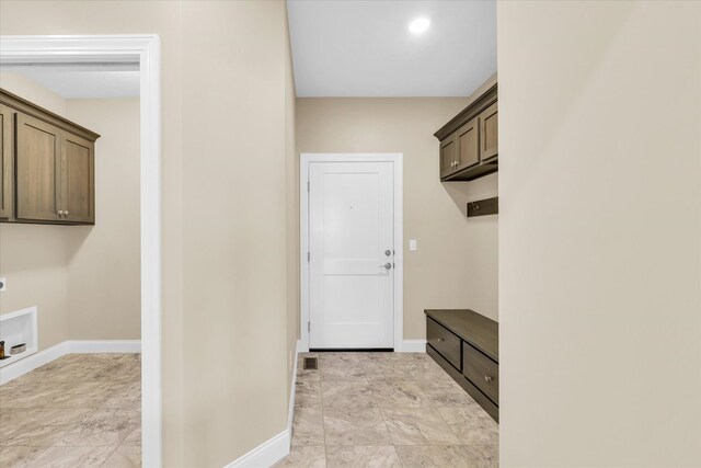 hall with light tile patterned floors