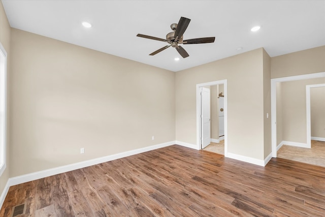 empty room with ceiling fan and hardwood / wood-style flooring