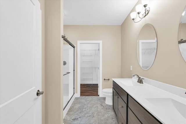 bathroom featuring walk in shower, hardwood / wood-style flooring, toilet, and dual bowl vanity