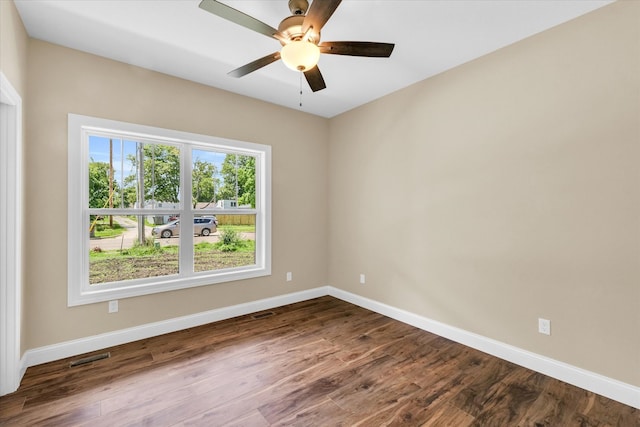 spare room featuring hardwood / wood-style floors and ceiling fan