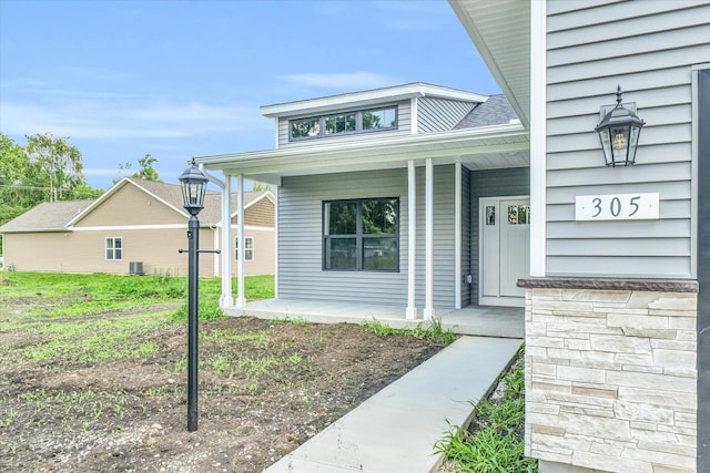 property entrance featuring a porch and central AC