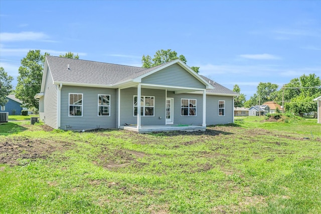 back of house featuring central AC and a lawn