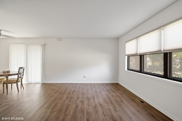 spare room featuring wood-type flooring and ceiling fan