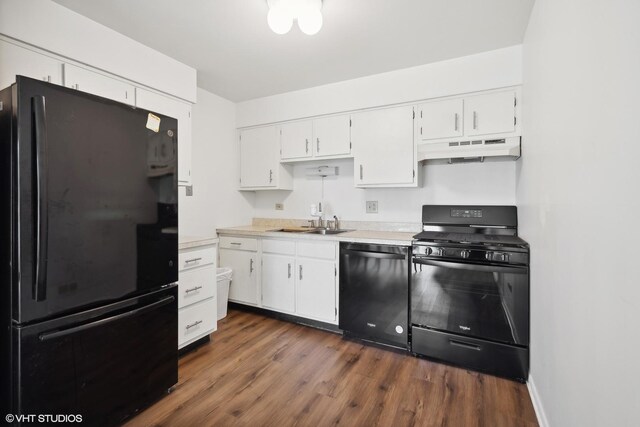 kitchen featuring black appliances, dark wood-type flooring, sink, custom exhaust hood, and white cabinets