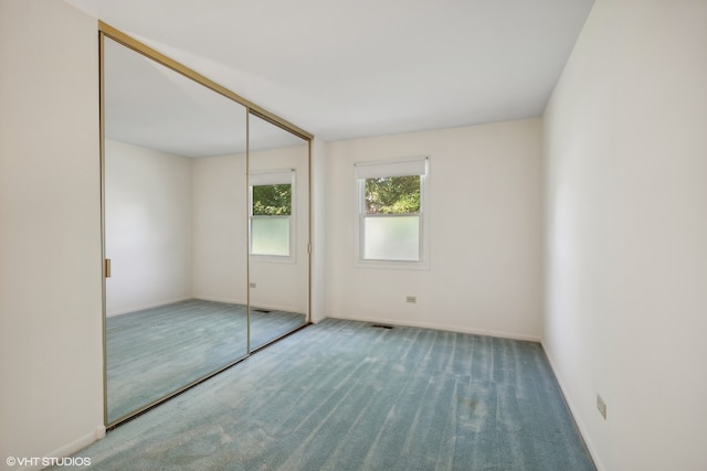 unfurnished bedroom featuring a closet and carpet floors