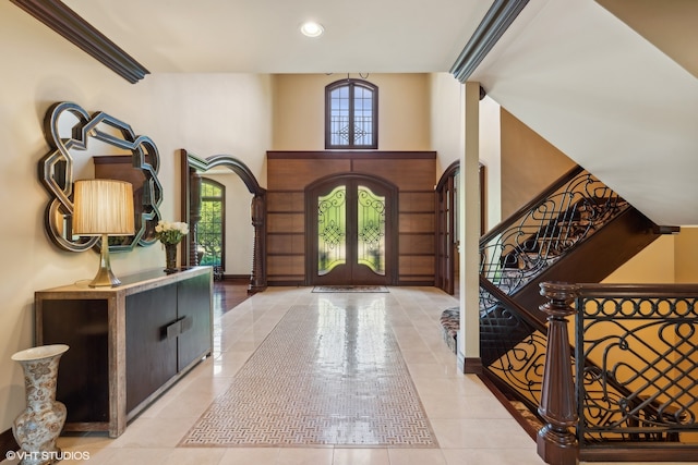 entryway with french doors and light tile floors