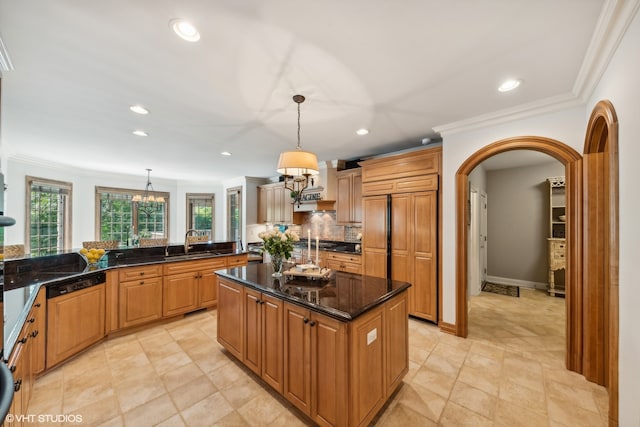 kitchen featuring sink, a center island, light tile floors, and pendant lighting