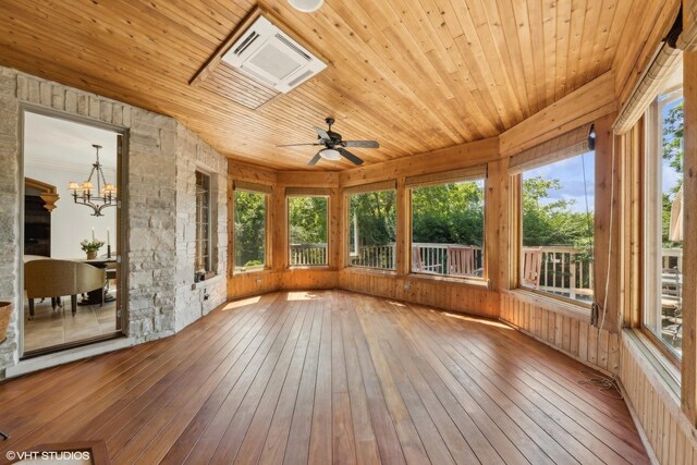 unfurnished sunroom featuring wooden ceiling and ceiling fan with notable chandelier