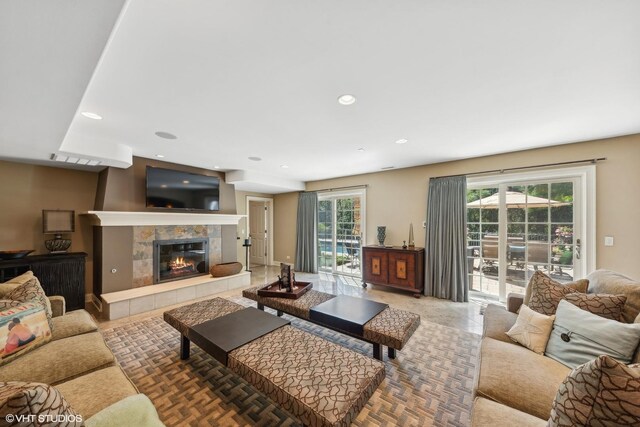 living room with a tiled fireplace