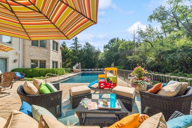 view of swimming pool featuring an outdoor living space and a patio