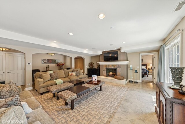 tiled living room with a fireplace