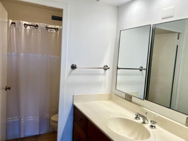 bathroom with tile patterned flooring, vanity, toilet, and a shower with shower curtain