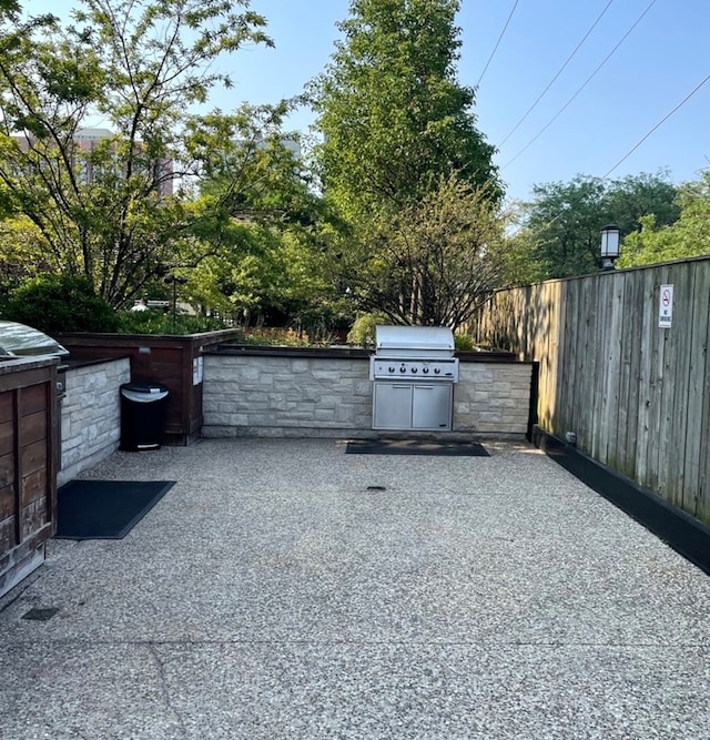 view of gate featuring a patio