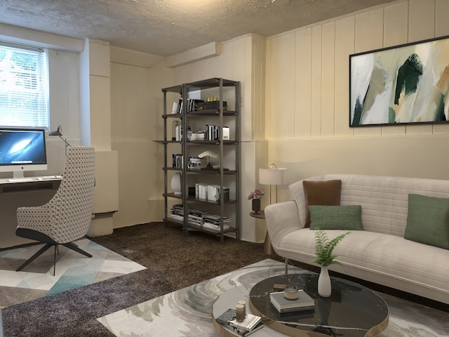 living room featuring dark carpet and a textured ceiling