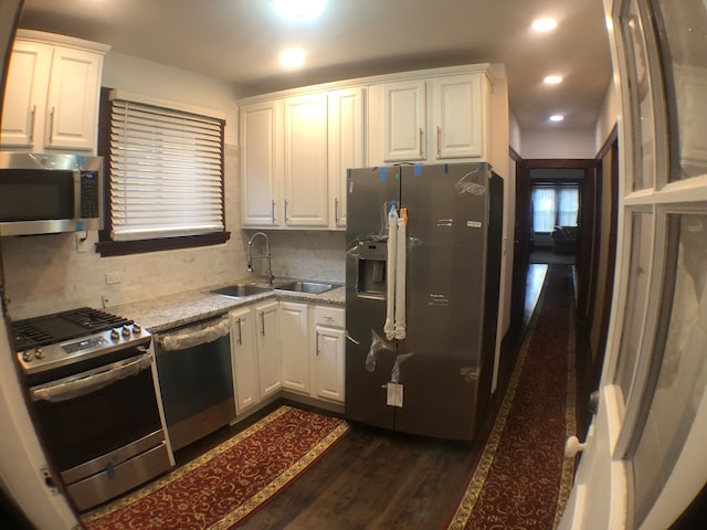 kitchen featuring sink, dark hardwood / wood-style flooring, white cabinetry, and appliances with stainless steel finishes