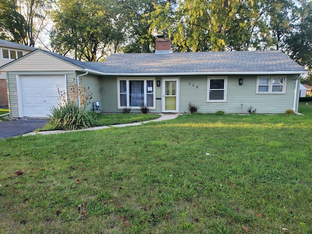 ranch-style home with a front yard and a garage