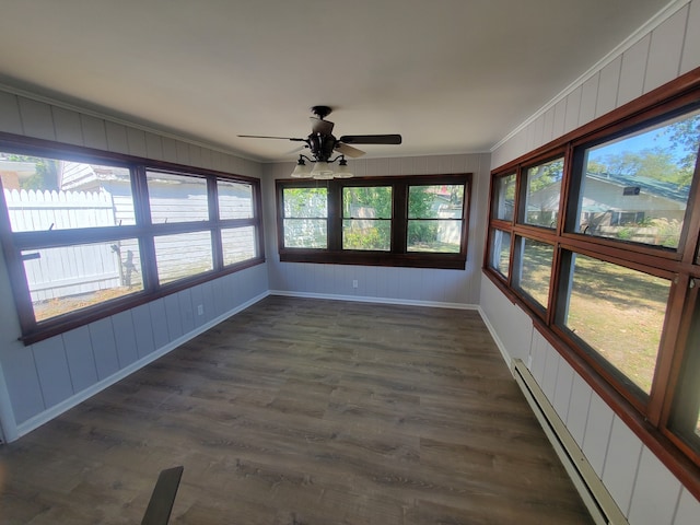 unfurnished sunroom featuring ceiling fan and a baseboard heating unit