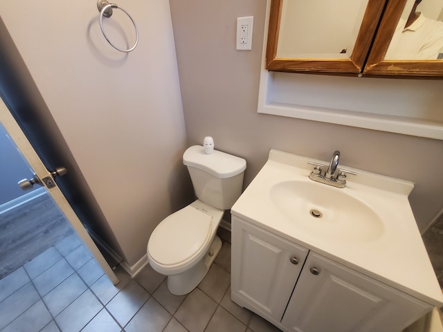 bathroom with tile patterned flooring, vanity, and toilet