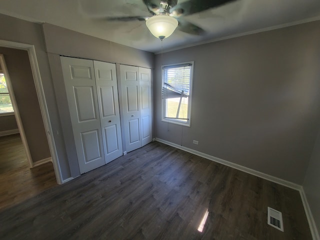 unfurnished bedroom with dark hardwood / wood-style flooring and ceiling fan