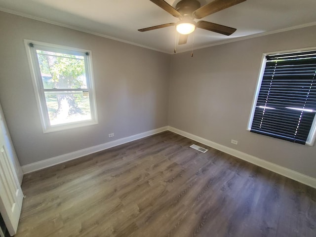 spare room with ceiling fan, dark hardwood / wood-style flooring, and ornamental molding