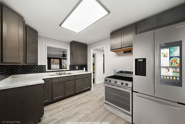 308 Minocqua St, Park Forest, IL 60466 - kitchen featuring appliances with stainless steel finishes, a sink, tasteful backsplash, light wood-type flooring, and light countertops
