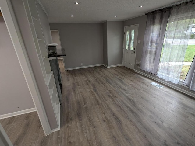 unfurnished living room with hardwood / wood-style flooring and a textured ceiling