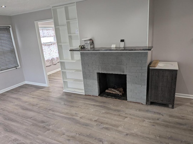 details with a fireplace, wood-type flooring, and a textured ceiling