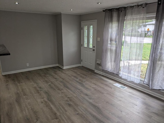 entryway with hardwood / wood-style floors and a textured ceiling