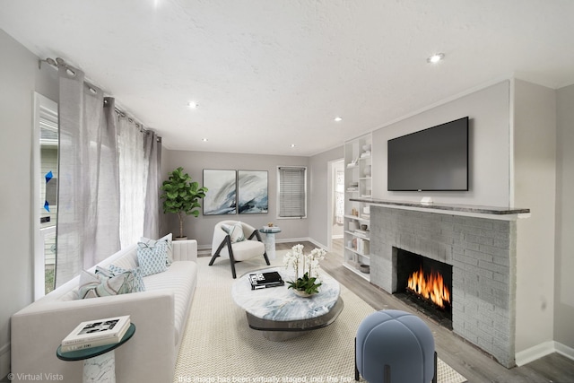 308 Minocqua St, Park Forest, IL 60466 - living area featuring a brick fireplace, wood finished floors, baseboards, recessed lighting, and built in shelves