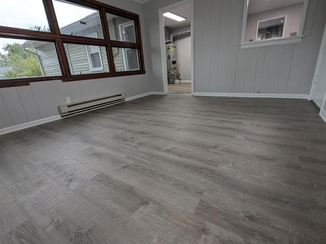 308 Minocqua St, Park Forest, IL 60466 - empty room featuring a baseboard radiator, baseboards, and wood finished floors