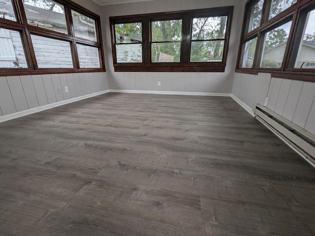 unfurnished sunroom with baseboard heating and a healthy amount of sunlight