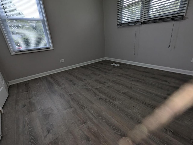 empty room featuring dark hardwood / wood-style flooring