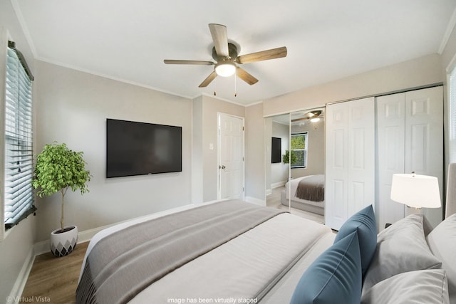 bedroom featuring hardwood / wood-style floors, ceiling fan, and crown molding