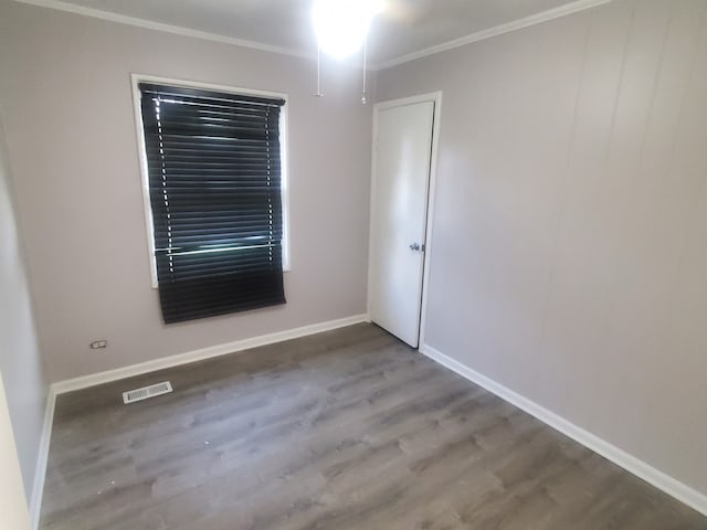 unfurnished room featuring crown molding and wood-type flooring