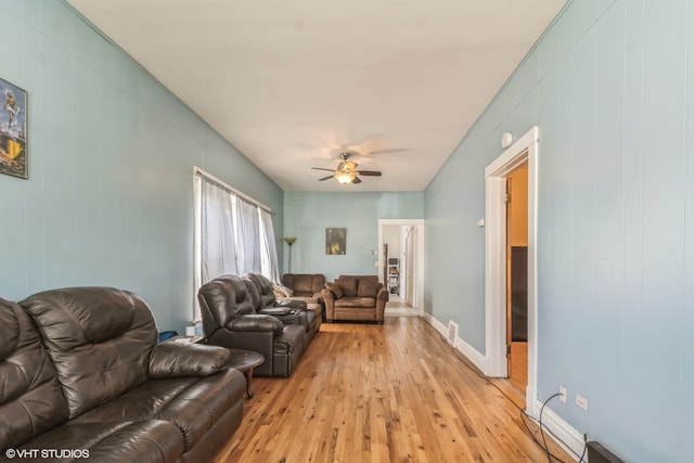 living room with light wood-type flooring and ceiling fan