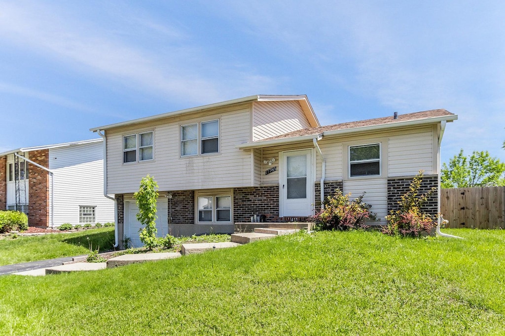 view of front of house featuring a garage and a front lawn