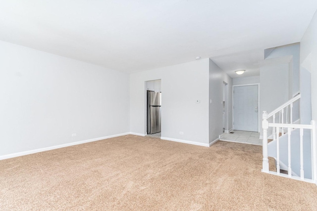 spare room featuring light colored carpet