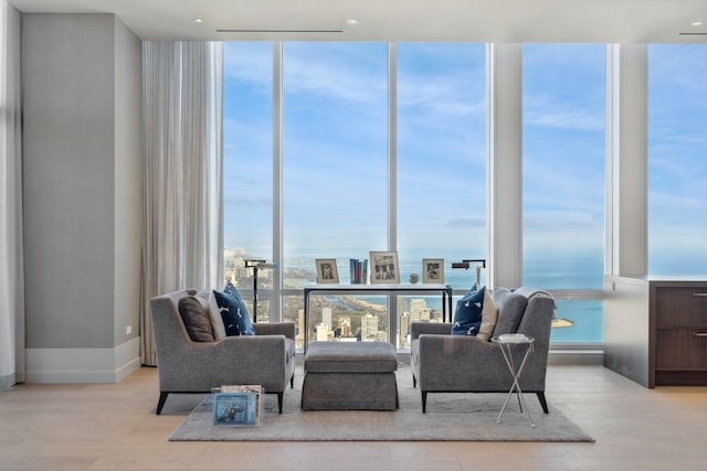 living area with expansive windows and a healthy amount of sunlight