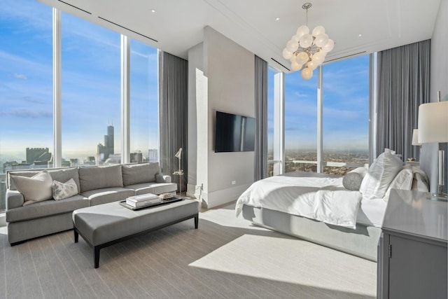 bedroom with a wall of windows and a notable chandelier