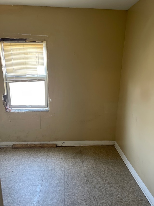 unfurnished room with tile floors