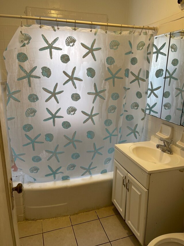 full bathroom featuring tile flooring, shower / tub combo, toilet, and vanity