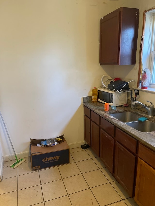 kitchen with sink and light tile flooring