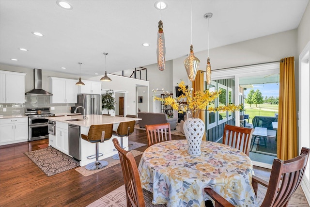 dining space with sink and dark wood-type flooring