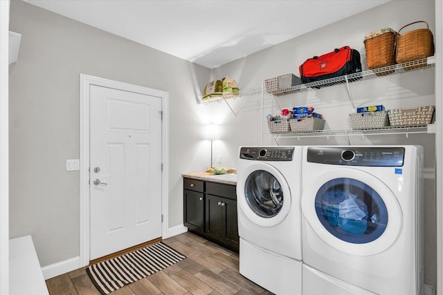 washroom with cabinets and washing machine and clothes dryer