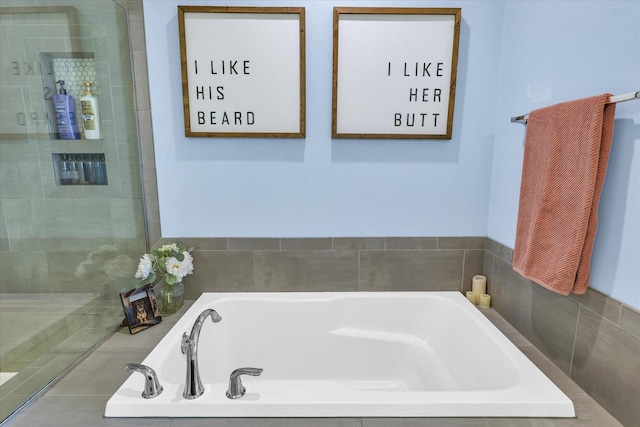 bathroom featuring shower with separate bathtub