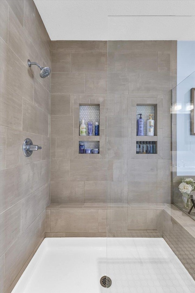 bathroom with tiled shower