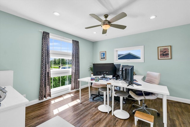 office featuring ceiling fan, a wealth of natural light, and dark hardwood / wood-style flooring