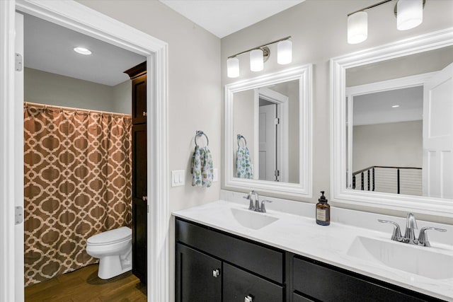 bathroom with hardwood / wood-style flooring, vanity, toilet, and a shower with shower curtain