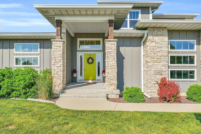 doorway to property with a lawn